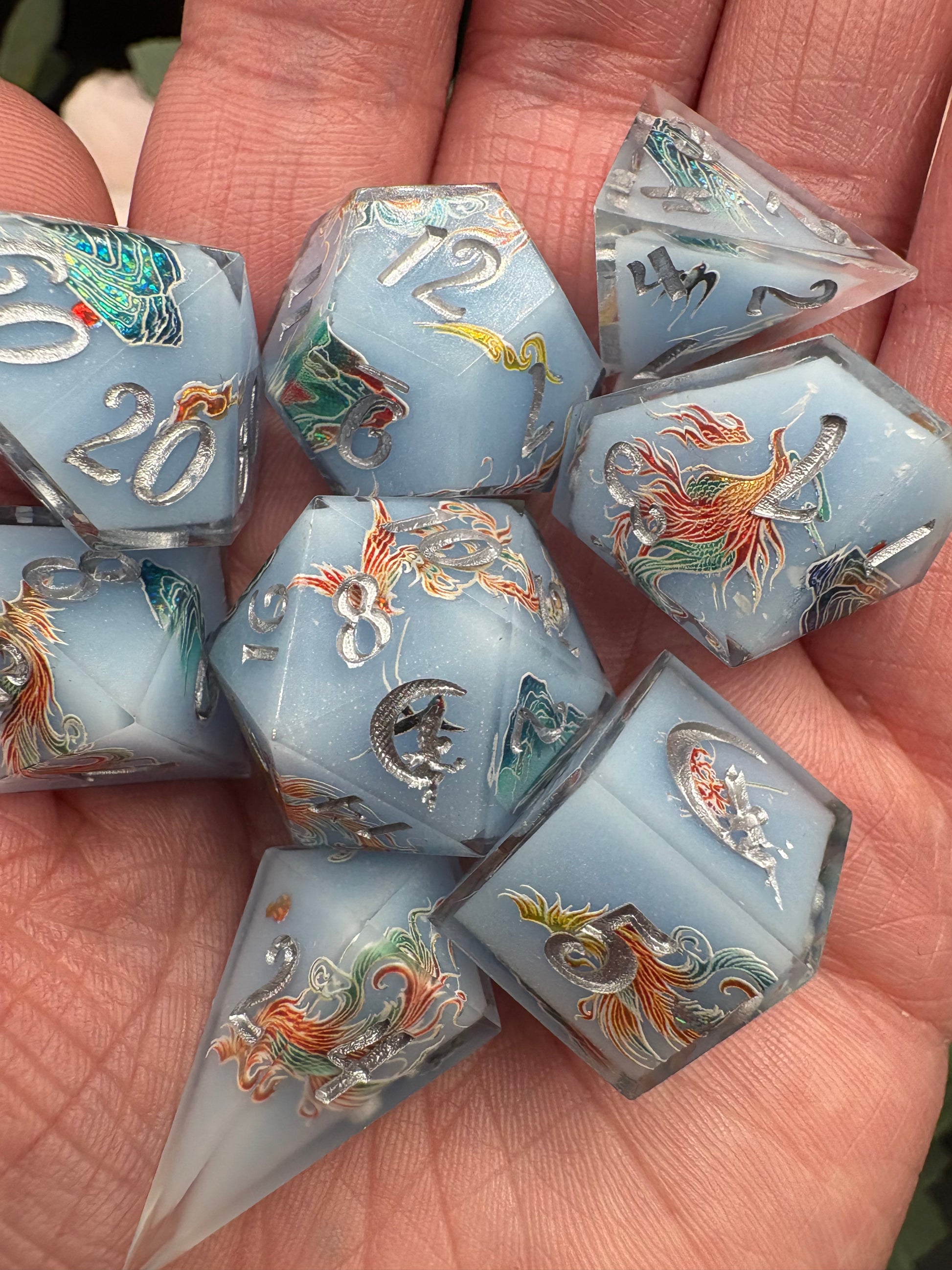 pale blue handmade dice set with phoenix and mountains