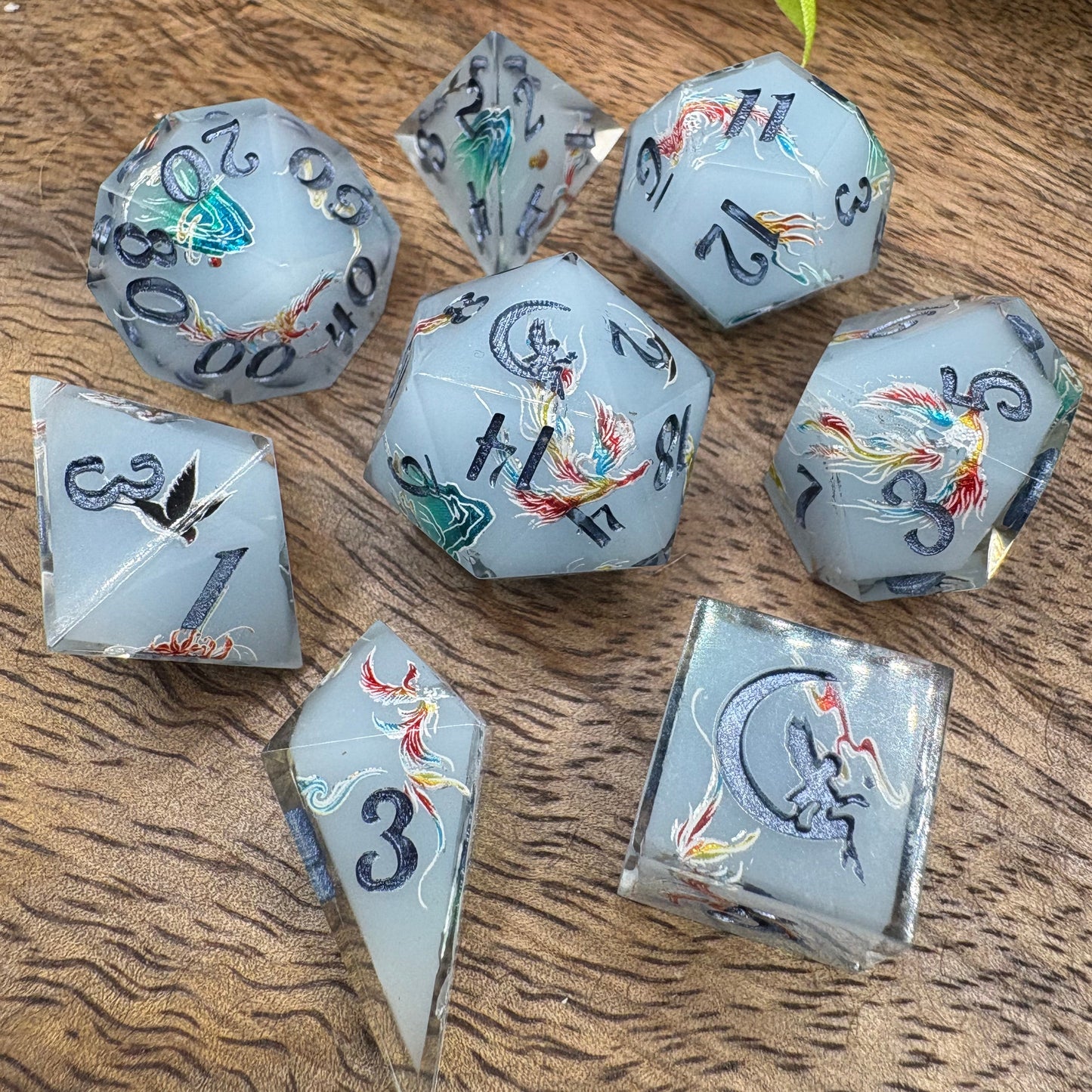 pale blue handmade dice set with phoenix and mountains - blue ink