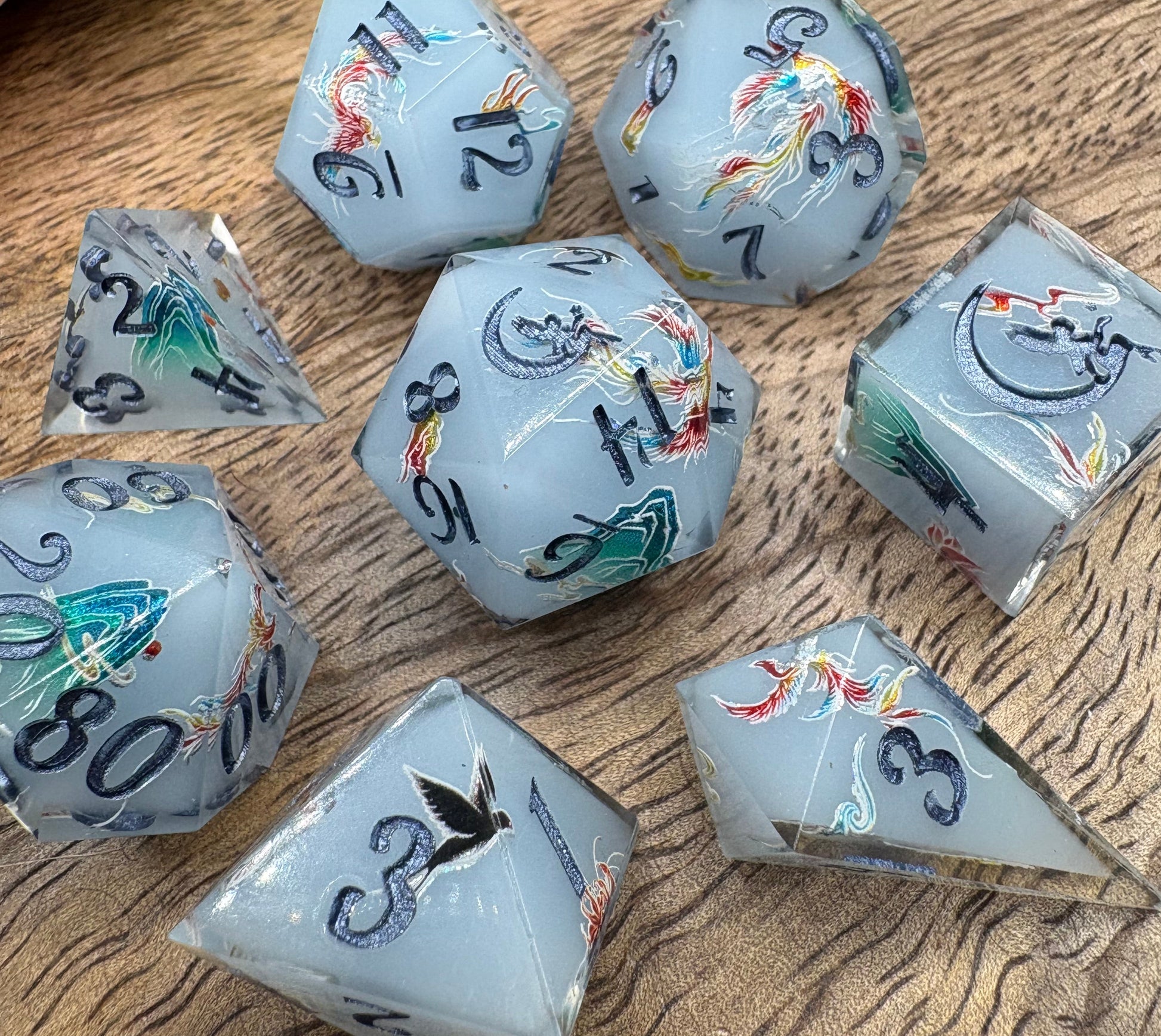pale blue handmade dice set with phoenix and mountains blue ink