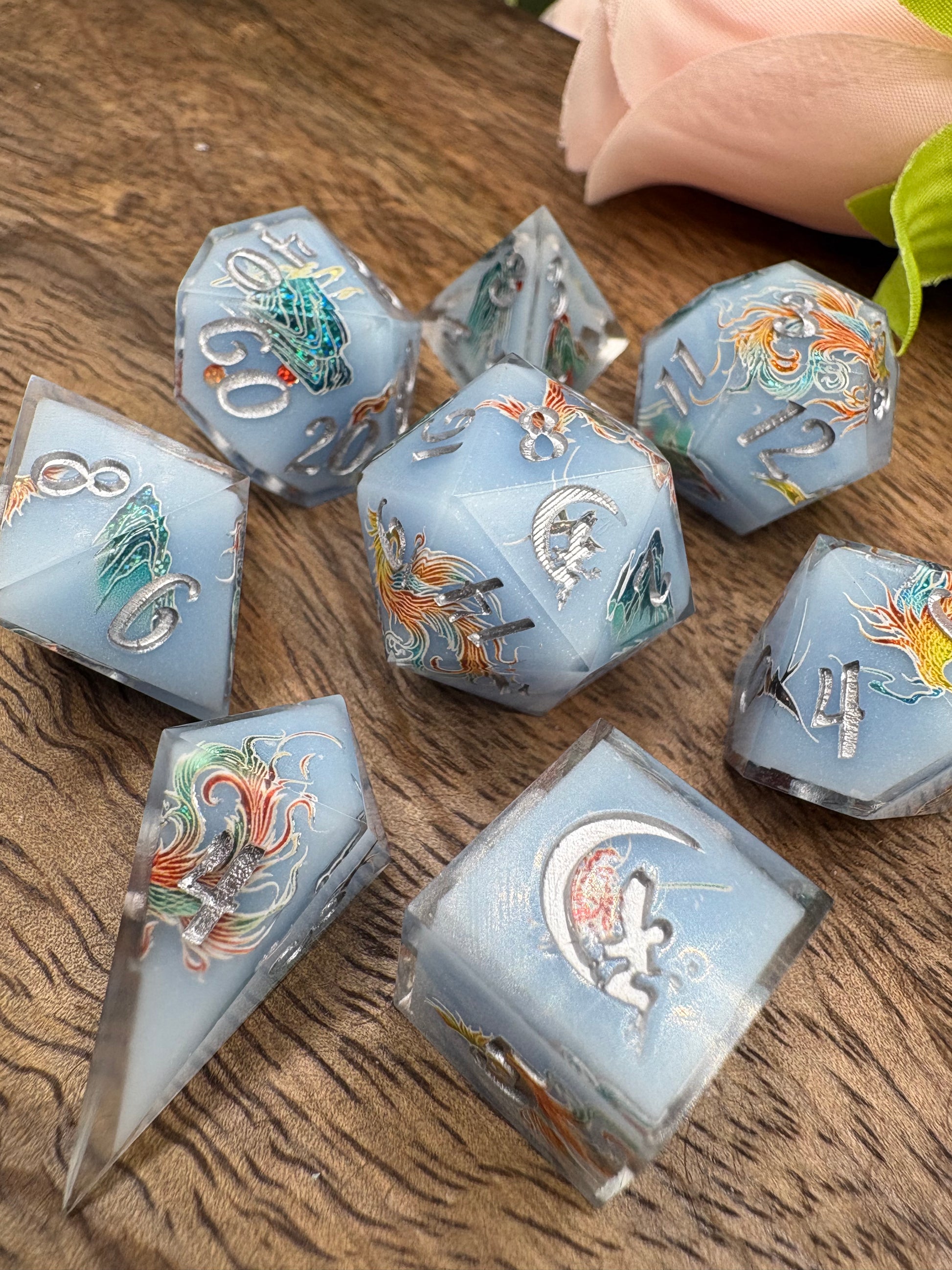 pale blue handmade dice set with phoenix and mountains
