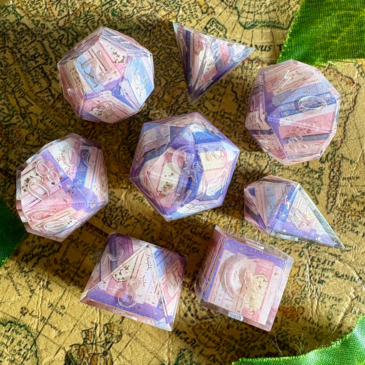 dice set with book spines in pinks, purples, blues. Shown uninked